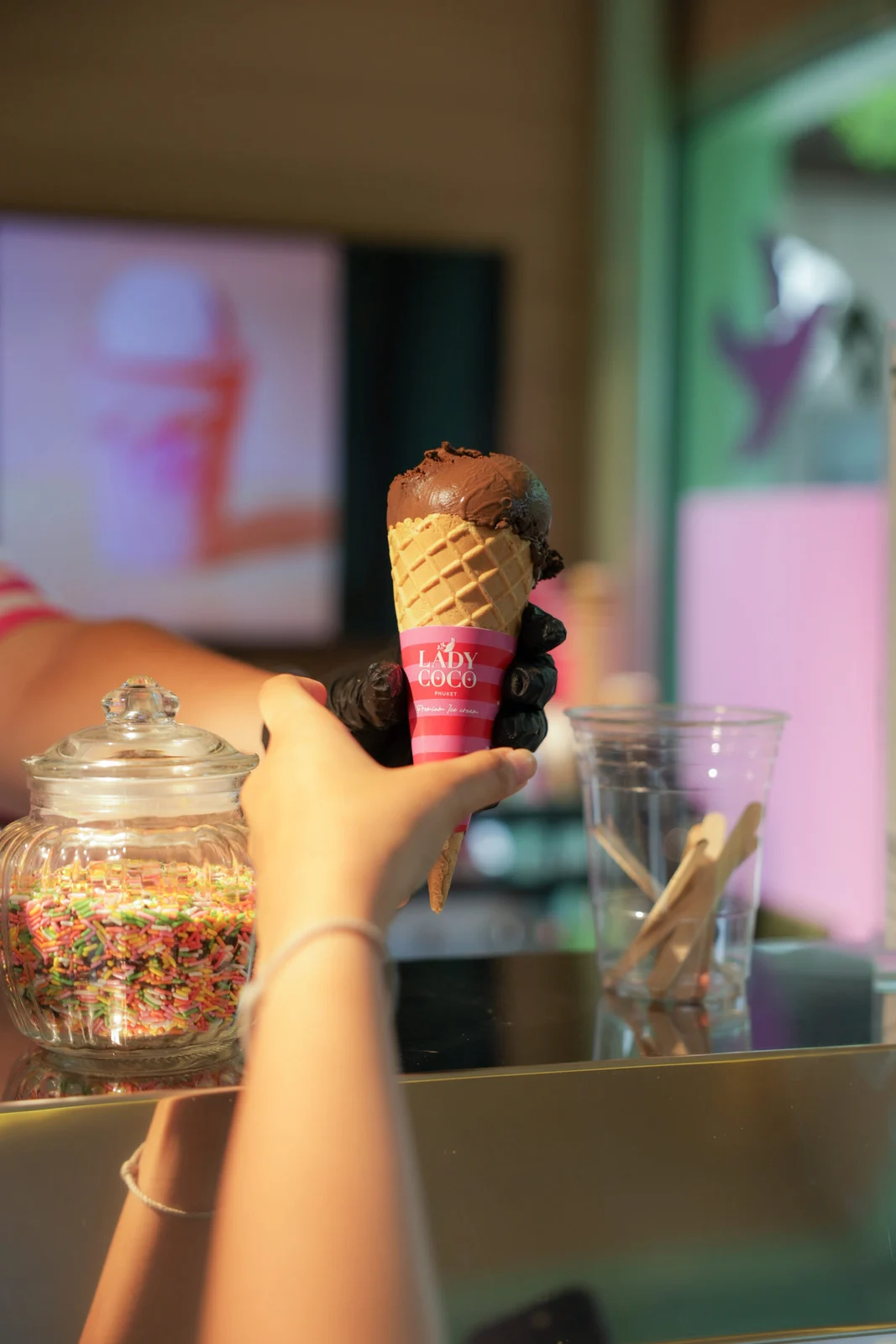 Ice cream cone held inside a Lady Coco shop